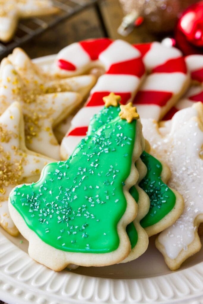 Christmas tree, star and cane shaped cutout sugar cookies with icing and sprinkles.  