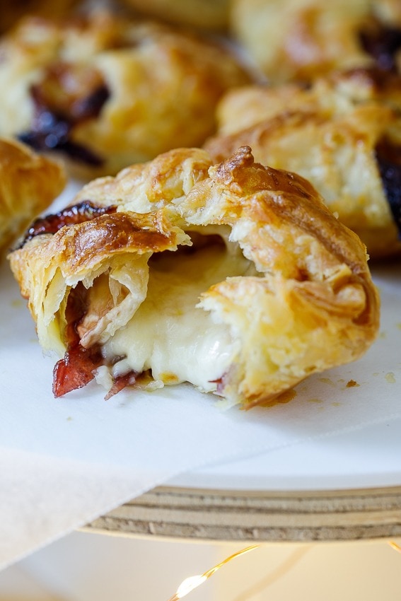 Cranberry brie pastry puffs cut open with creamy filling. 