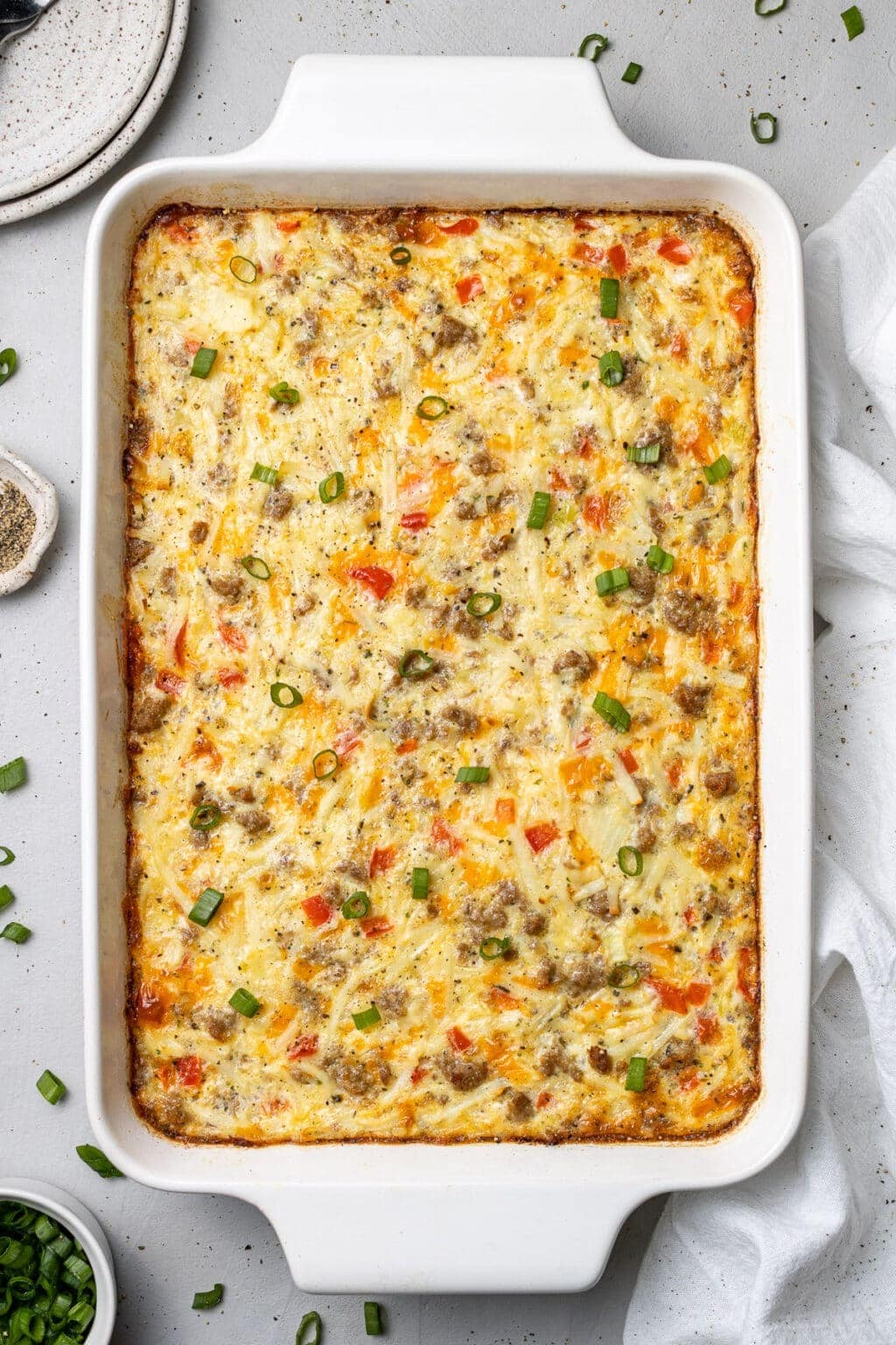 Egg Casserole With Hash Browns, breakfast sausage, dried parsley, dried basil, pepper, onions, bell peppers and cheddar cheese