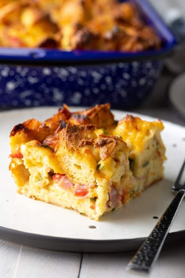 Slice of fluffy strata on a plate.