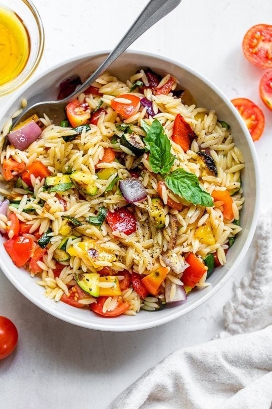 Orzo salad with fresh tomatoes, fragrant basil, and drizzled with olive oil.