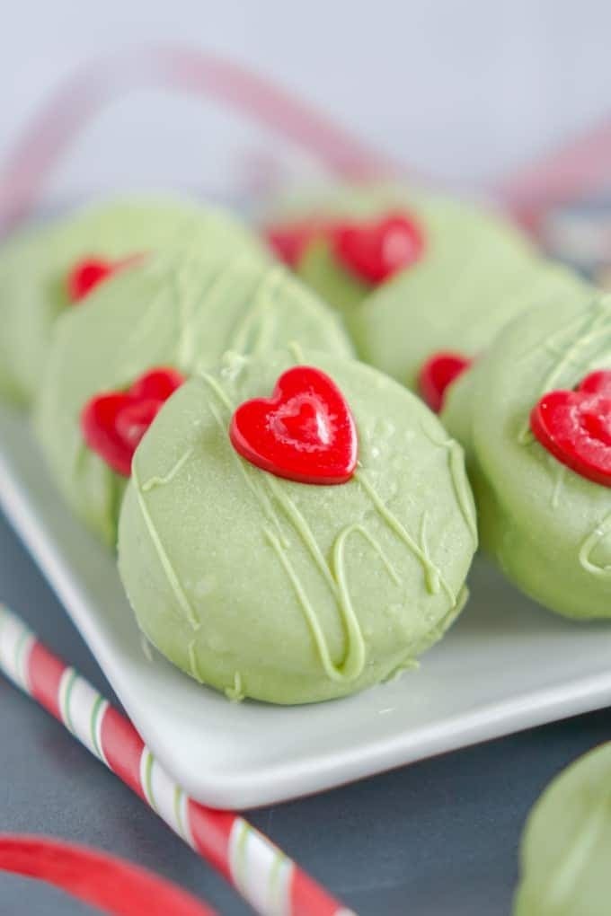 Cookies coated with green colored chocolate on a plate. 