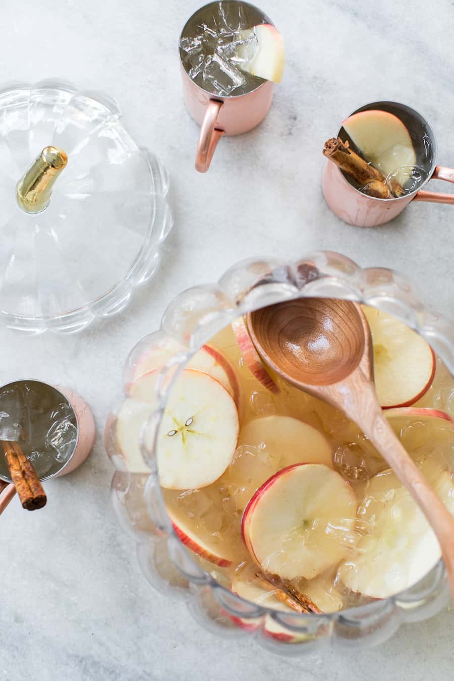 Hard cider kombucha punch cocktail on mule glasses and punch bowl. 