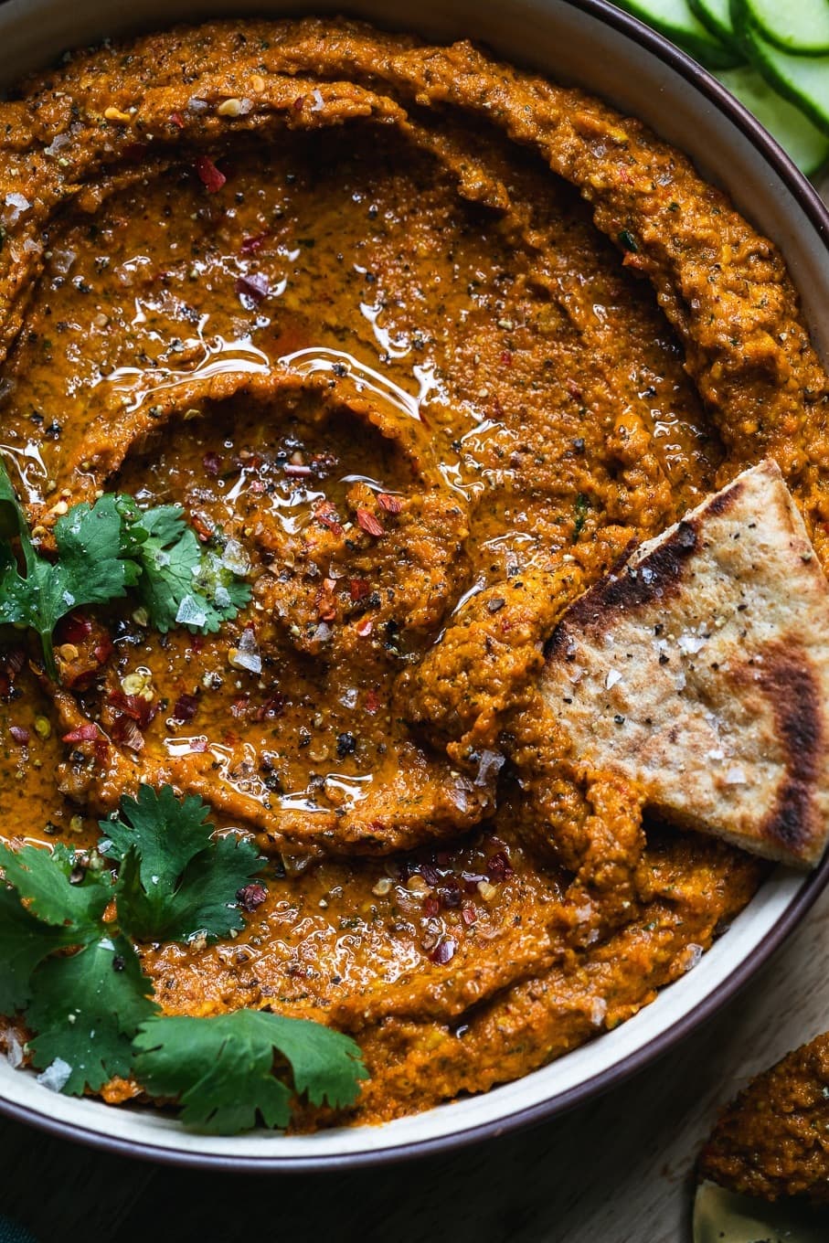 Bowl of homemade Harissa Carrot Dip garnished with cilantro