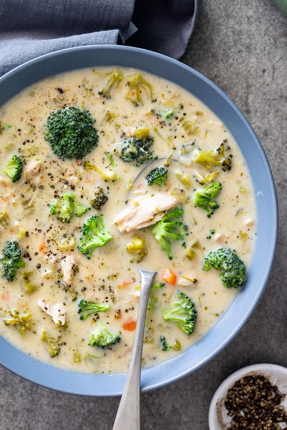 Creamy chicken broccoli soup in a bowl with spoon. 