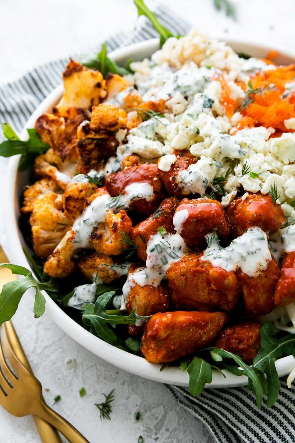 Hearty buffalo chicken bowls with spicy chicken, fresh greens, and brown rice.