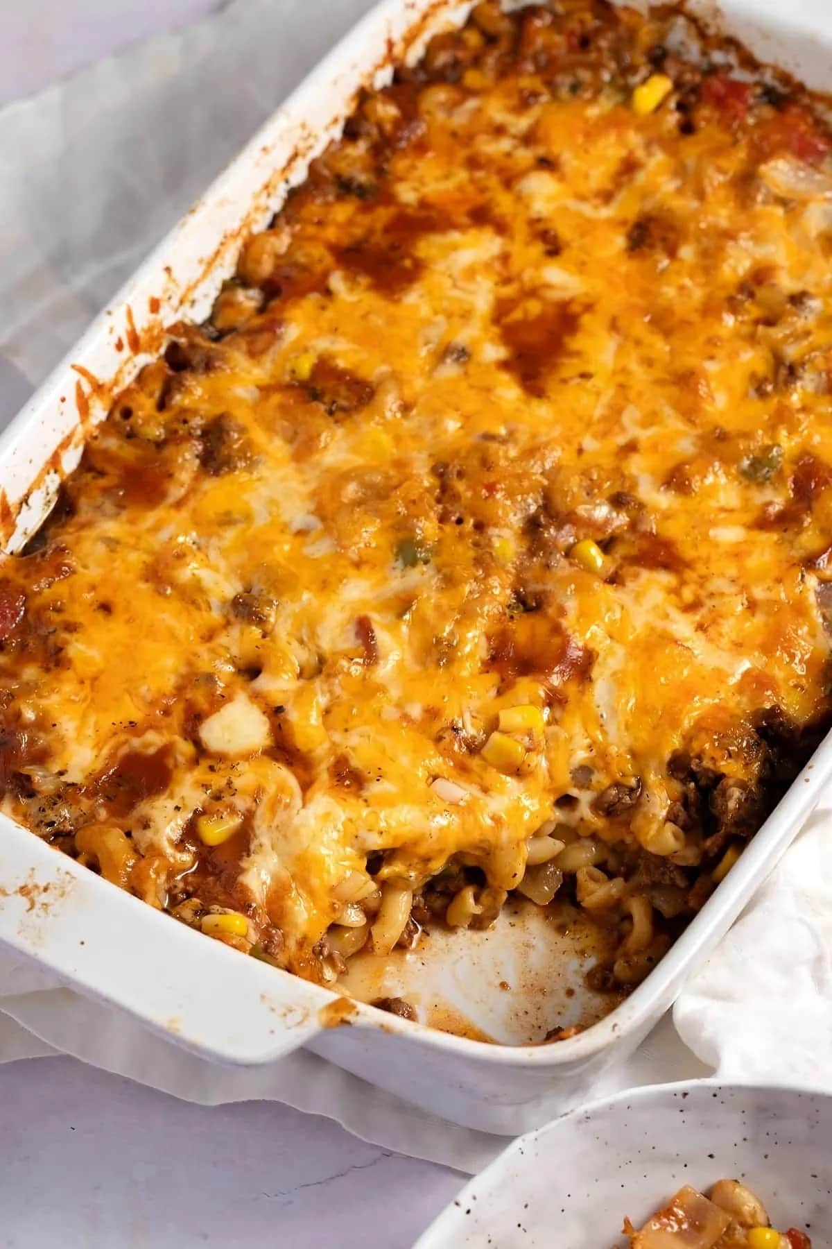Cheeseburger casserole cooked in a white dish. 