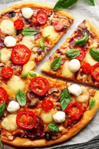 Homemade Pizza with Tomatoes, Basil and Mozzarella Cheese