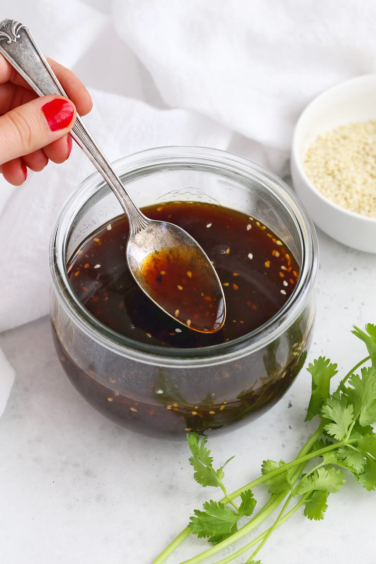 A tangy and sweet condiment teriyaki sauce in a glass container