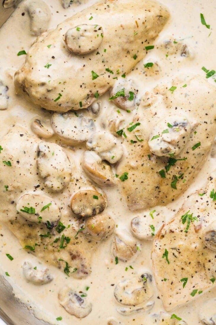 A delicious chicken dish with mushrooms, herbs and creamy sauce, cooked in a skillet