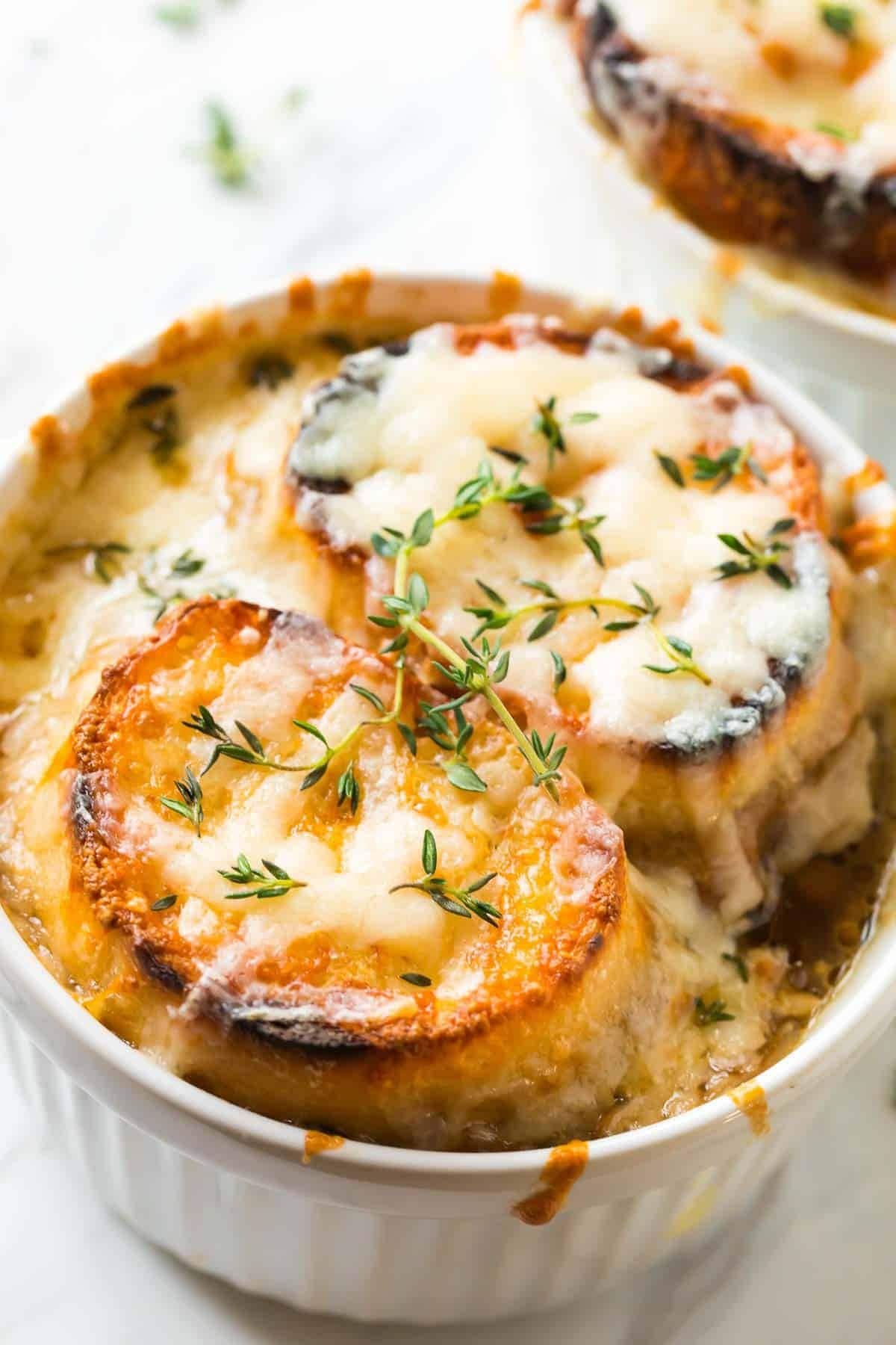 Close up view of homemade Instant Pot French Onion Soup garnished with thyme
