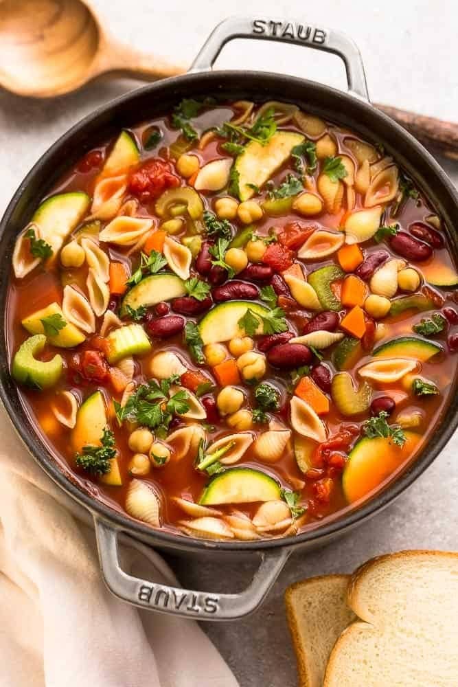 Top view of an Instant Pot Minestrone Soup with carrots, dice tomatoes, zucchini, kidney beans, cannellini beans and baby spinach