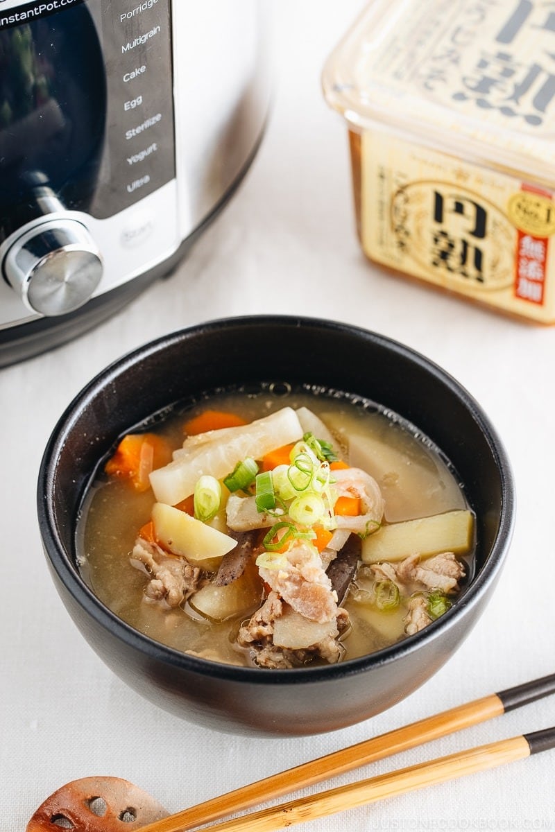 Bowl of homemade Instant Pot Pork and Vegetable Miso Soup with carrots, potatoes, Japanese radish, burdock roots, kanjac, shiitake mushrooms, deep-fried tofu pouch, bean sprouts, and green onions