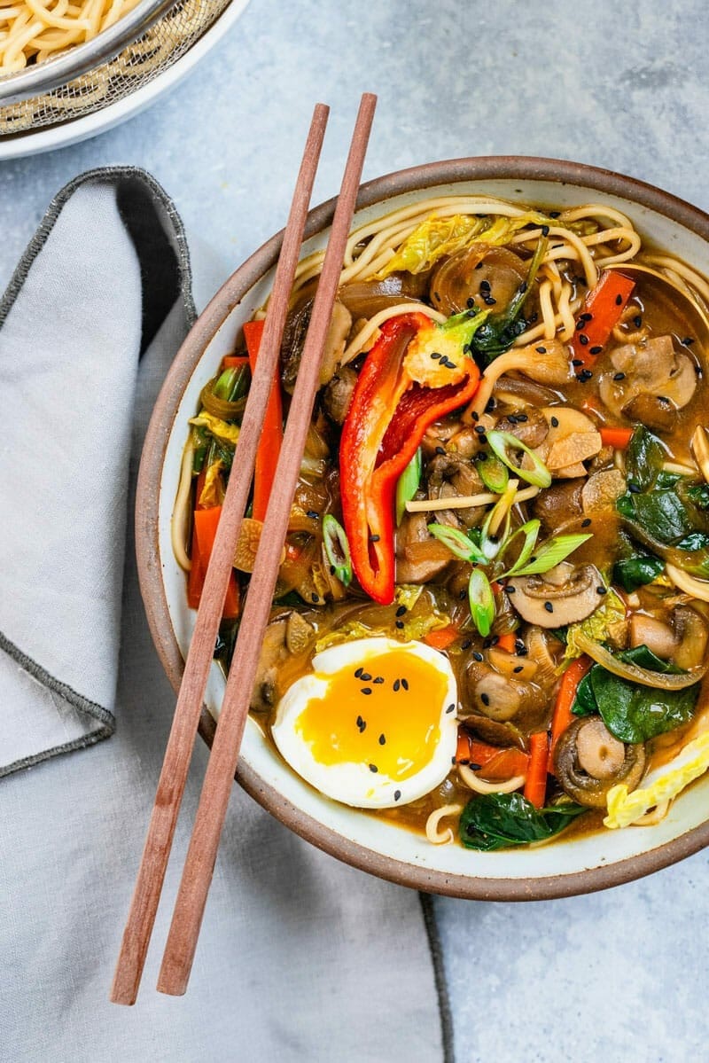 Bowl of homemade Instant Pot Ramen noodles with miso paste, napa cabbage, carrots, mushrooms, bell peppers and soft boiled egg