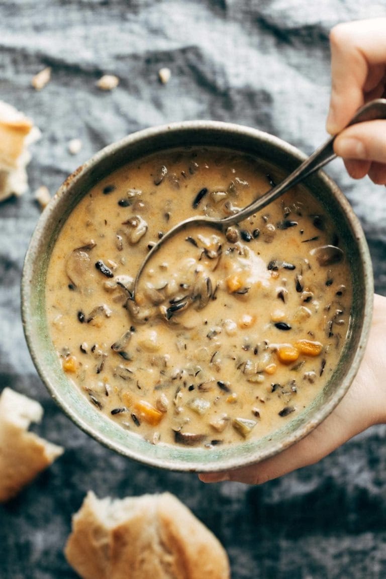 Bowl of homemade Instant Pot Wild Rice Soup with thinly sliced mushrooms, carrots and celery
