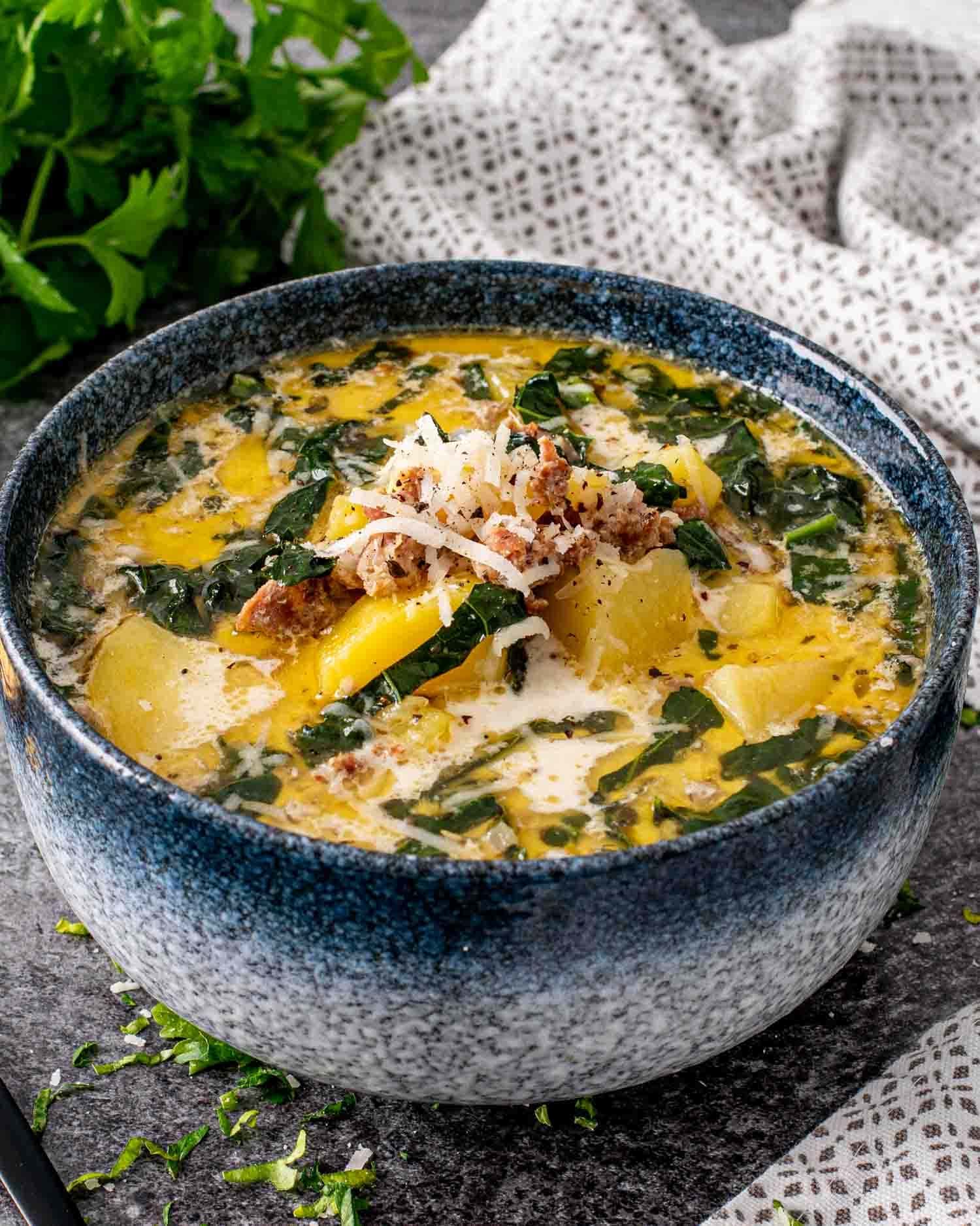 Bowl of homemade Instant Pot Zuppa Toscana with Italian sausage, potatoes and kale