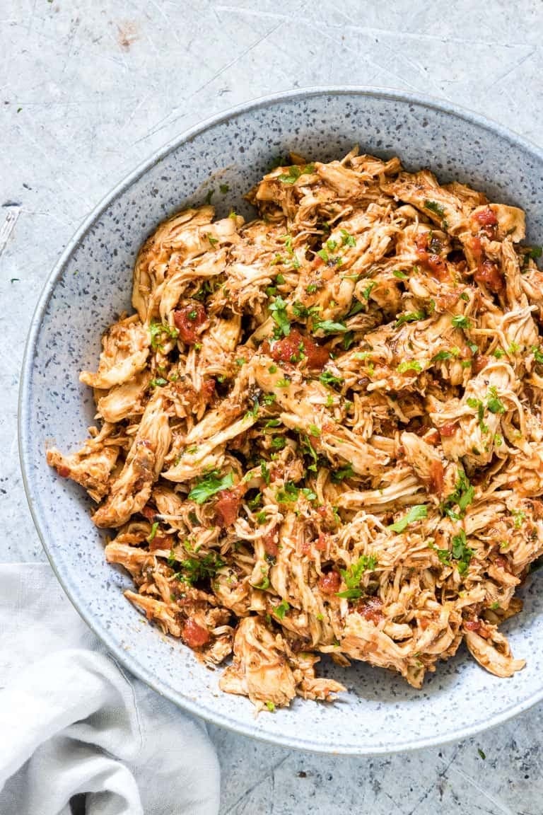 Top view of instant pot shredded chicken on a gray plate.