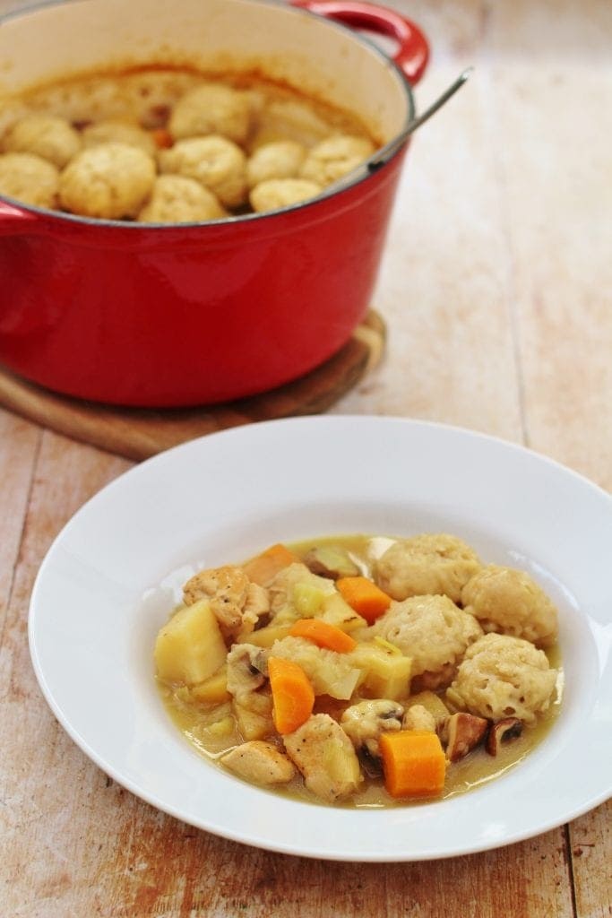 Leftover chicken stew with dumpling, carrots and potatoes served on a white plate. 