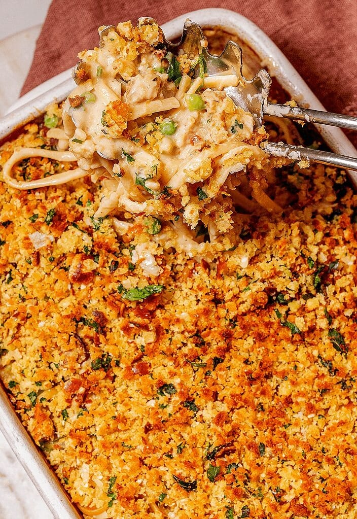 Turkey tetrazzini in a baking dish  topped with melted cheese and breadcrumbs.. 