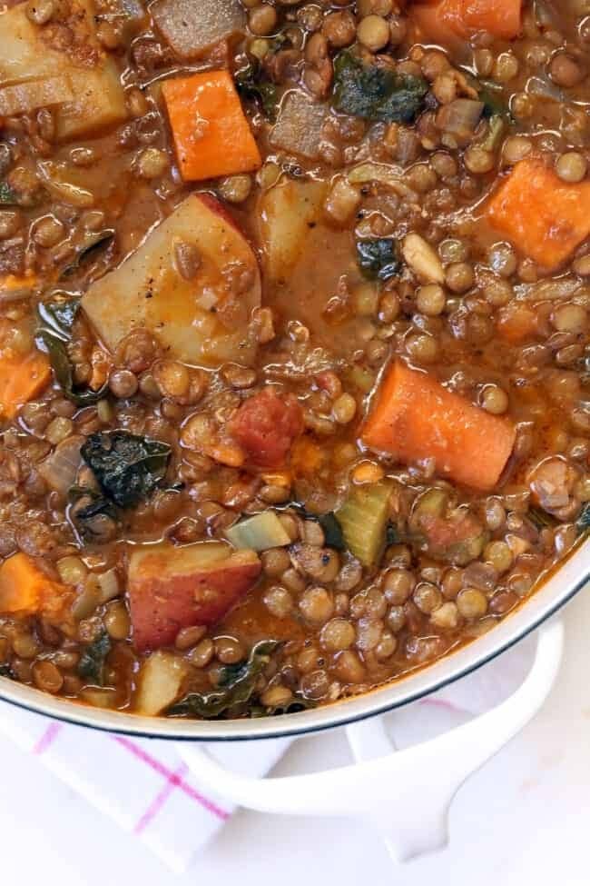 Pot of lentil stew packed with vegetables. 