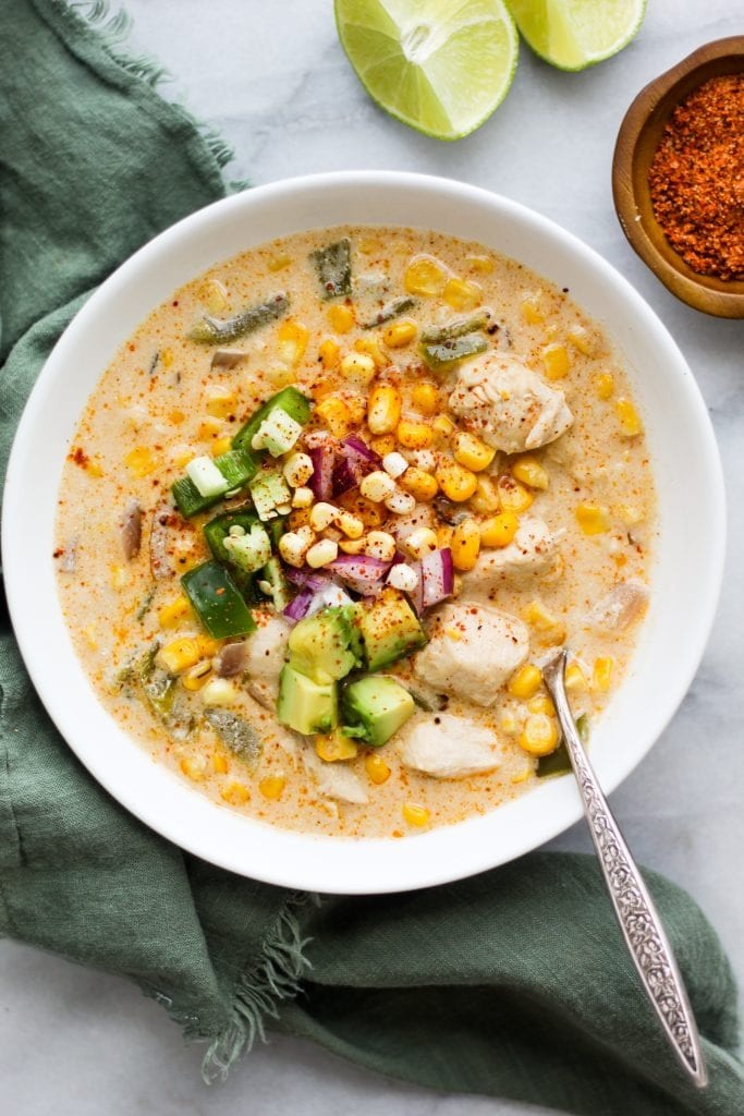 Mexican Street Corn and Chicken Chowder on a bowl with a spoon. 