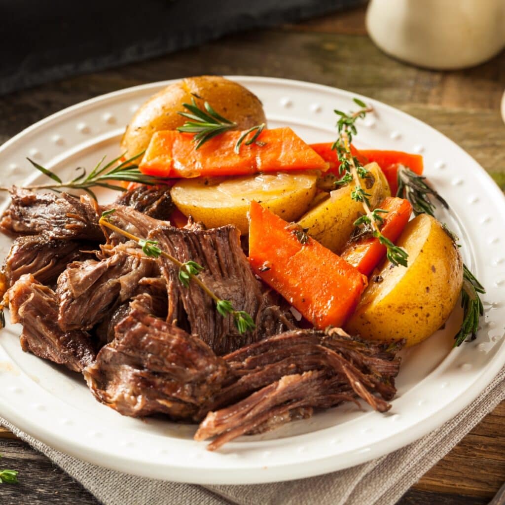 Mississippi Pot Roast served with carrots and potatoes.