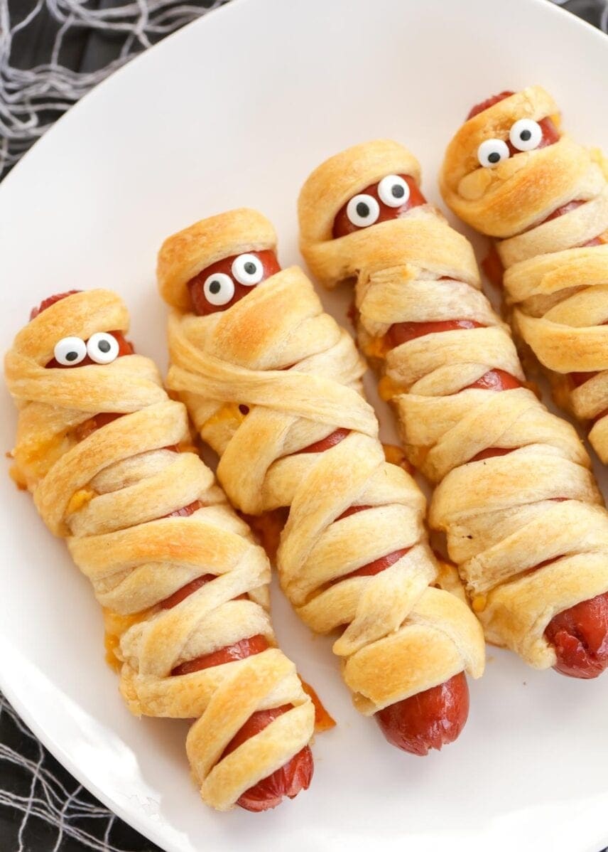 Mummy hotdogs with candy eyes. 
