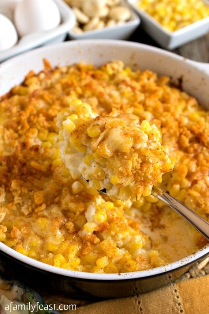 Nantucket corn pudding in a baking dish with spoon. 