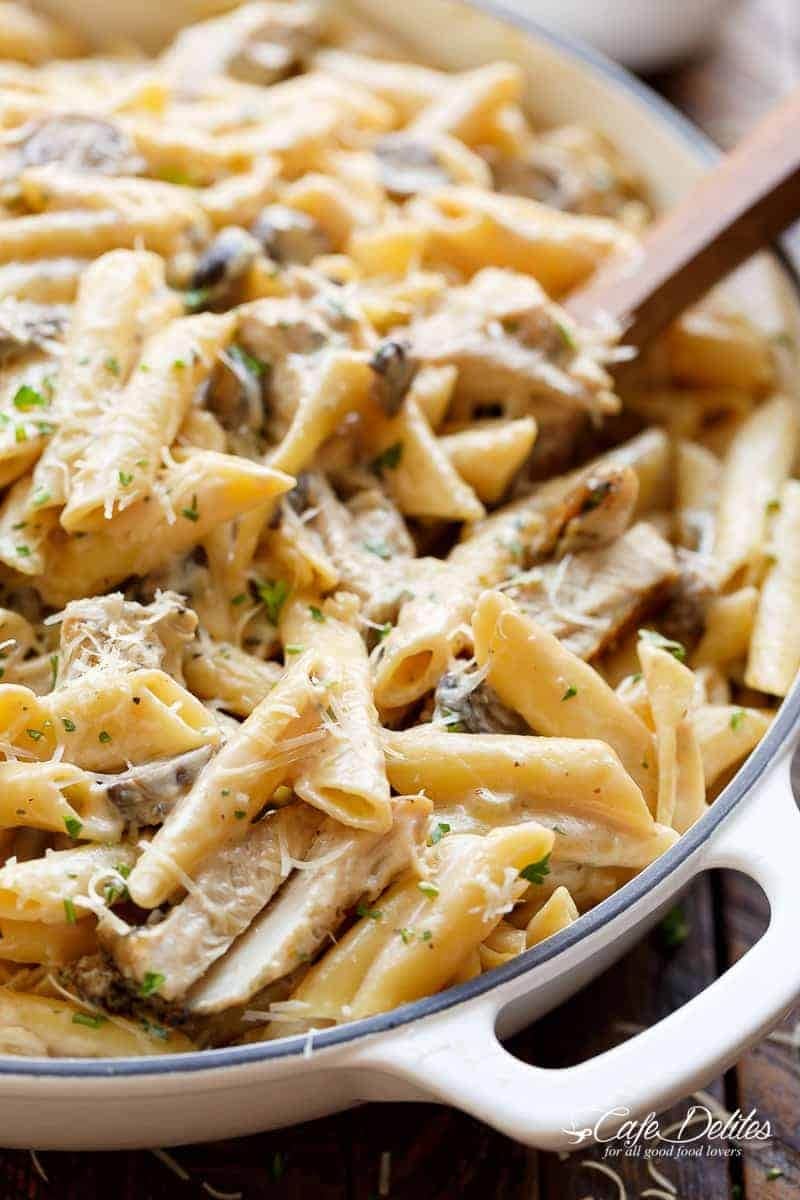 Delicious pasta with chicken and mushrooms in white casserole