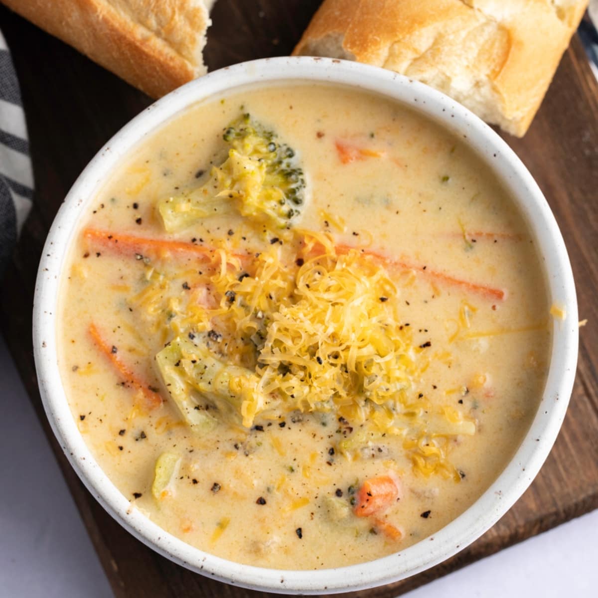 A bowl of Panera broccoli soup garnished with cheese. 