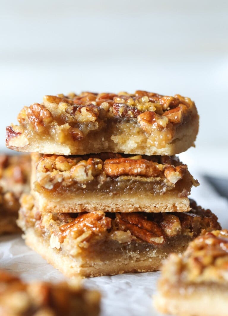 Stacked slices of pecan pie bars.