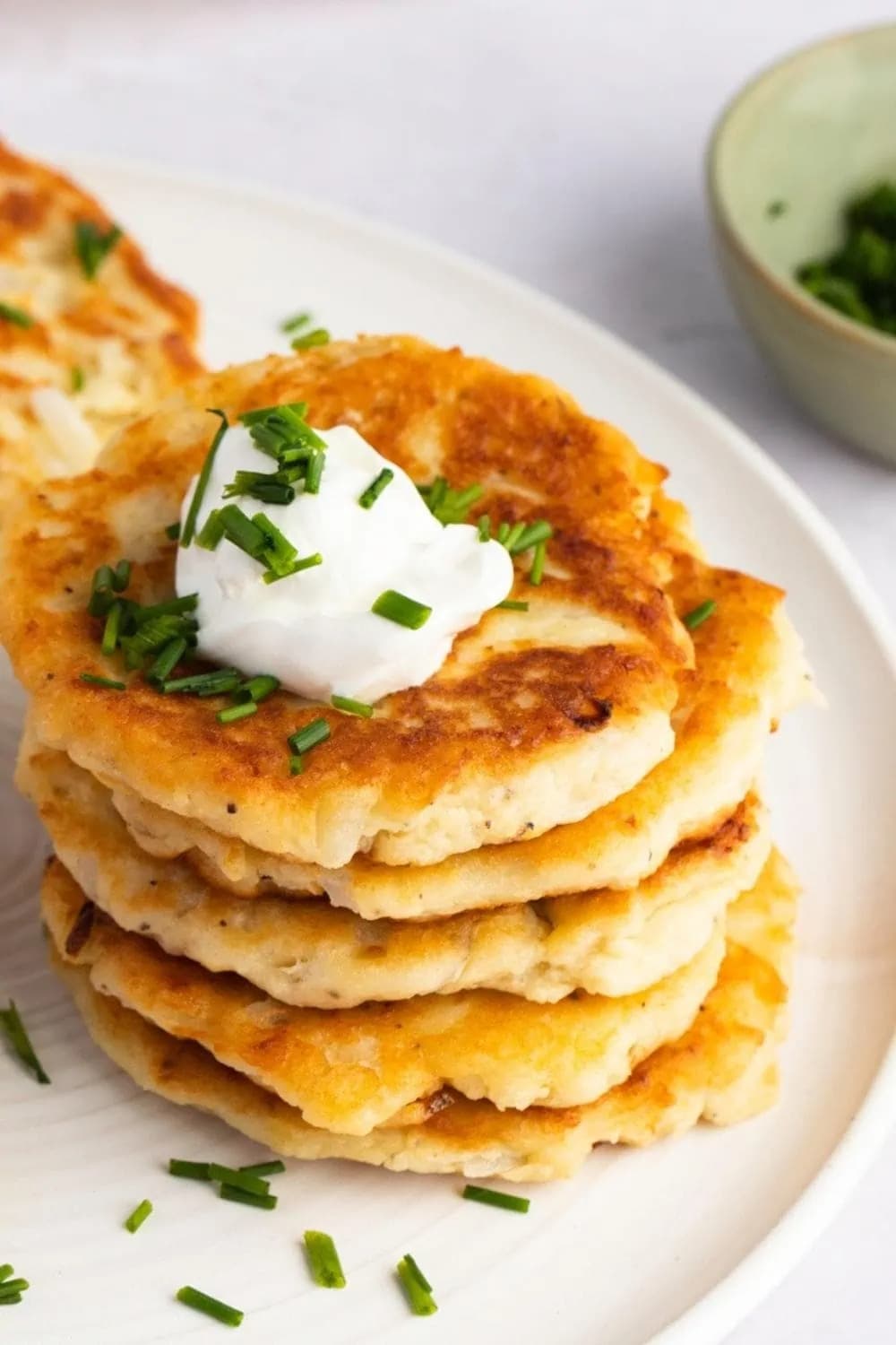Stack of leftover mashed potato cakes served on plate. 