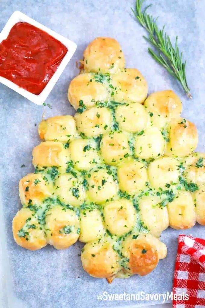 Christmas trees shaped pull apart bread drizzled with a mixture of melted butter, parmesan, and herbs. 