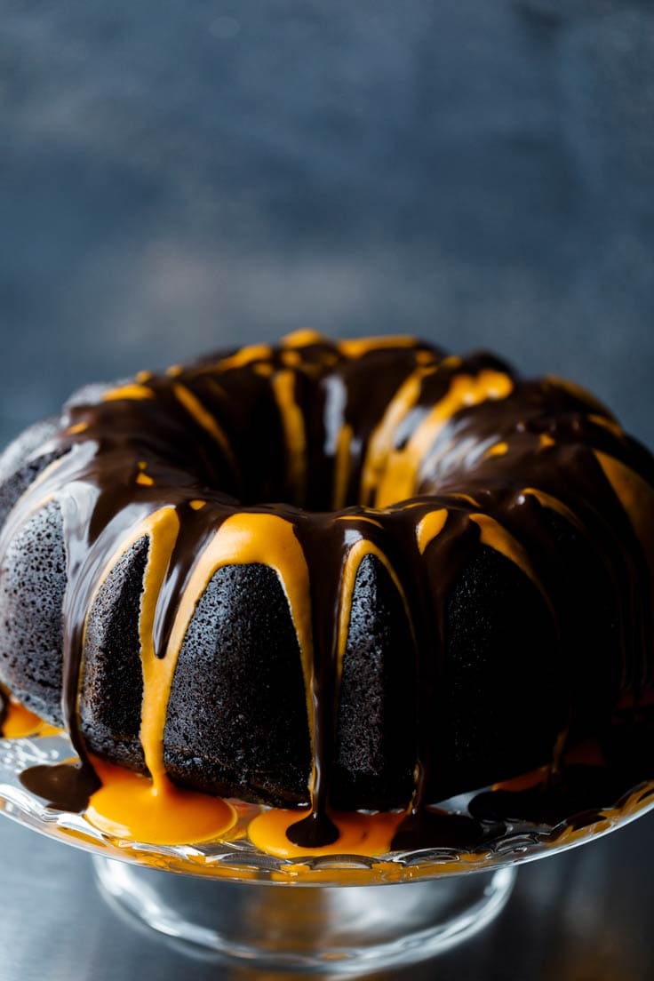 Pumpkin chocolate cake in a cake tray with dripping caramel syrup. 
