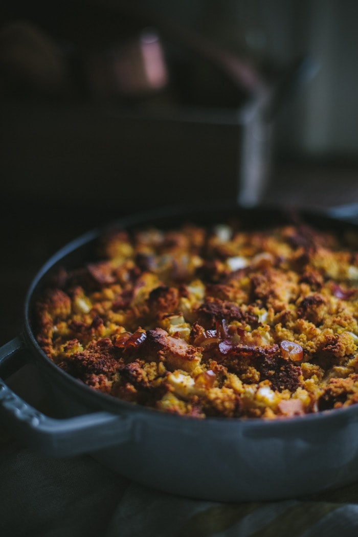 Pumpkin cornbread stuffing with bacon and dates in a pot. 