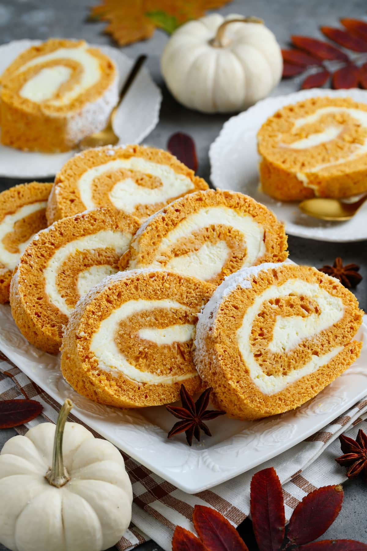 Pumpkin Roll Cake with Cream Cheese Frosting on a Plate