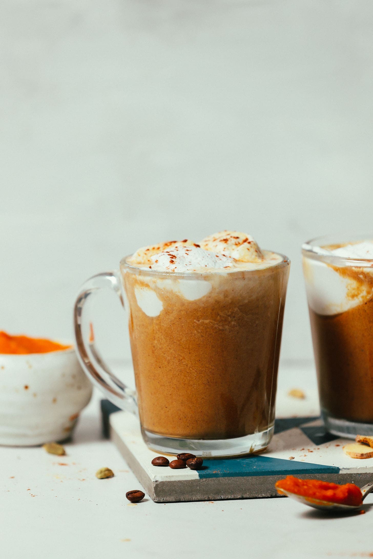 Two glasses of pumpkin spice latte. 