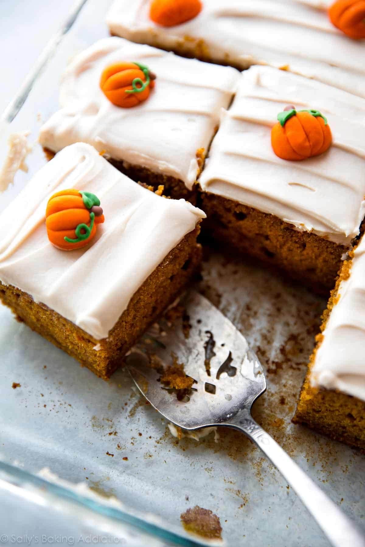 Sliced pumpkin cake topped with creamy frosting. 