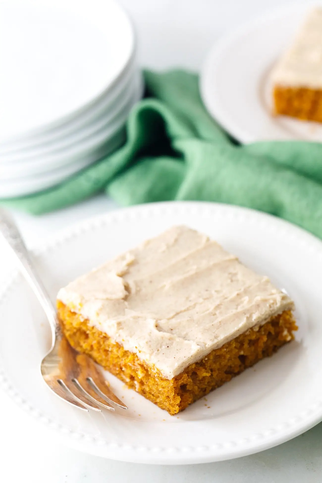 Slice of pumpkin cake with brown butter frosting. 