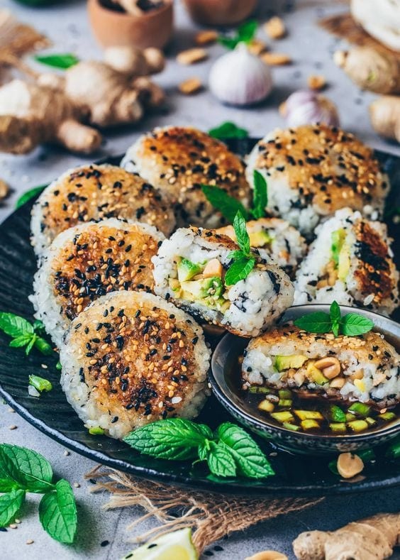 Japanese rice balls coated in dipping sauce and sesame seeds.