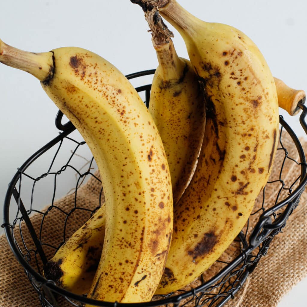 Ripe bananas on a wire basket. 