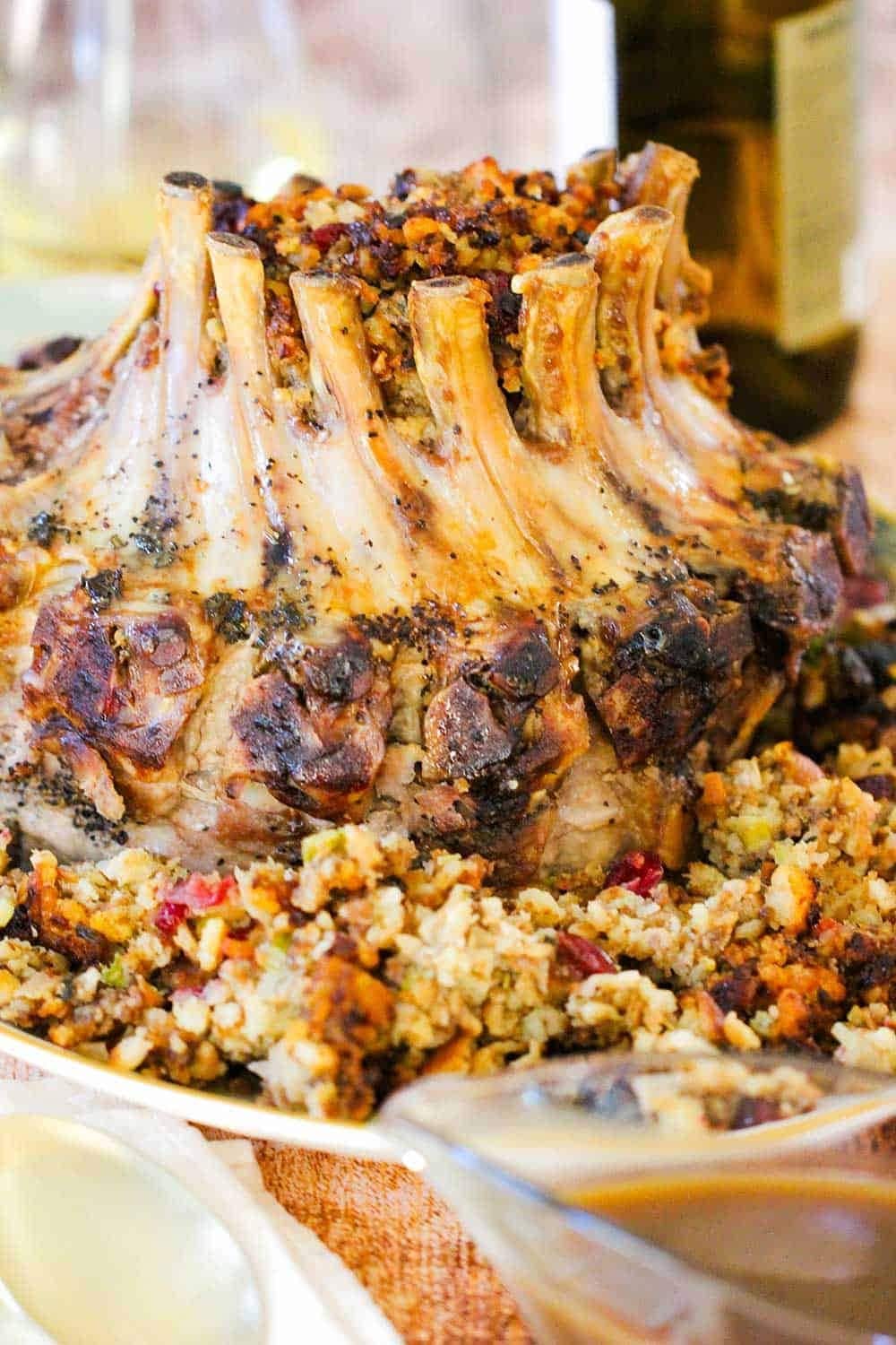 Roasted pork ribs arranged in crown on a bed of stuffing. 