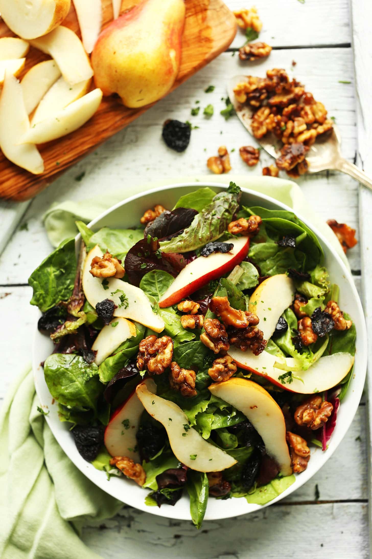 Bowl of pear balsamic salad with dried cherries and crunchy, candied walnuts. 