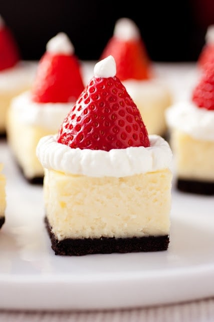 Santa Hat Cheesecake Bites with Whipped Cream and Fresh Strawberries