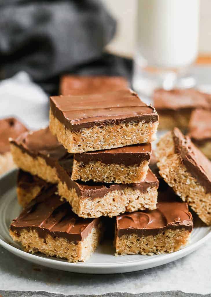 A plate with a stack of scotcheroos chocolate peanut butter bars