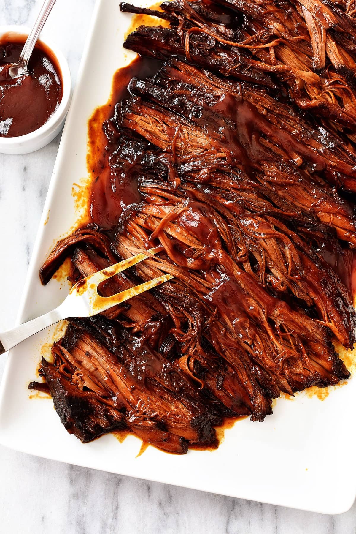 Slow-Cooker Brisket with a bowl of sauce on the side
