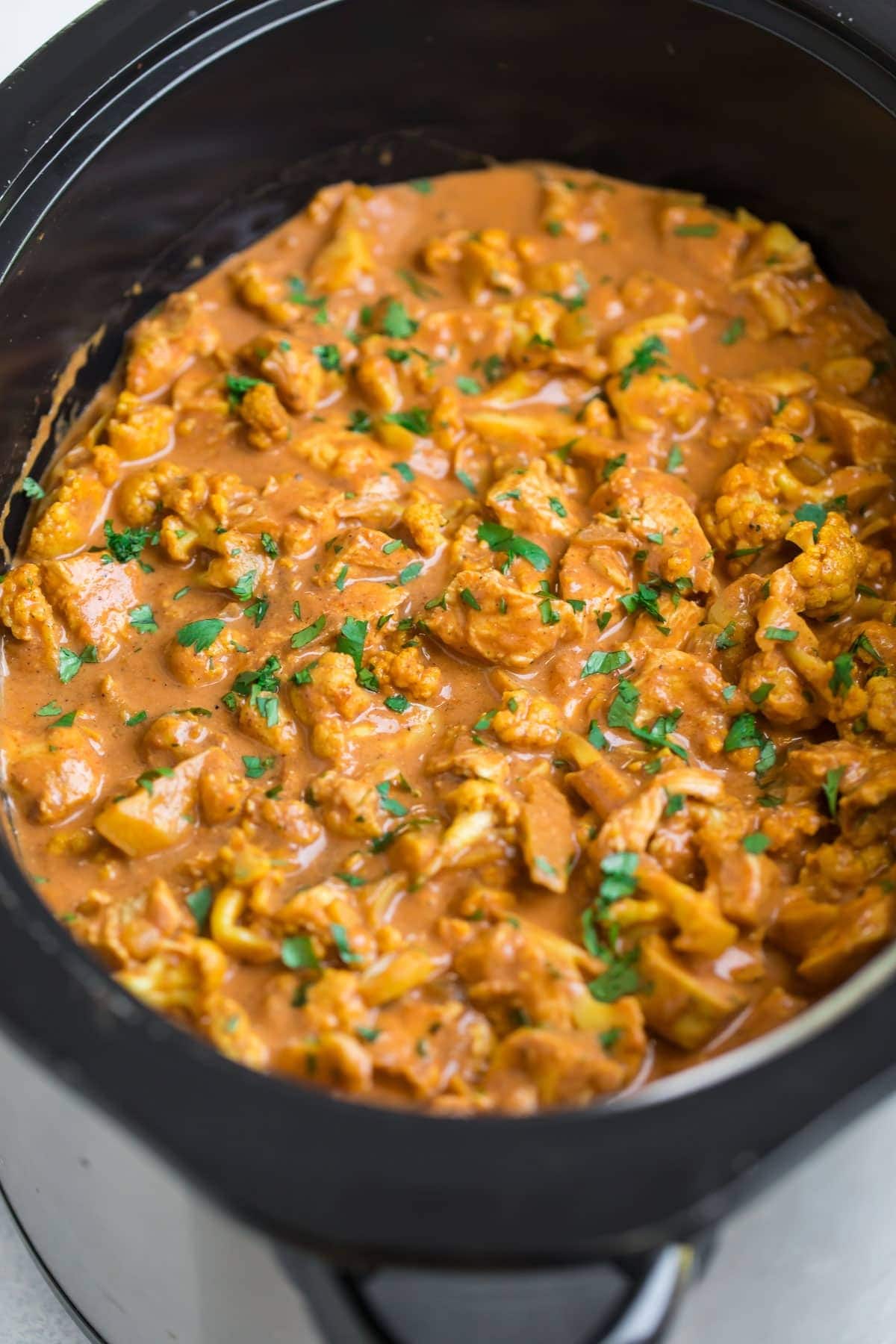 Slow Cooker Butter Chicken Curry garnished with chopped fresh cilantro