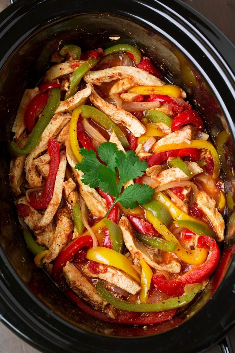 Slow Cooker Chicken Fajitas strips of chicken breast, bell peppers and garnished with parsley