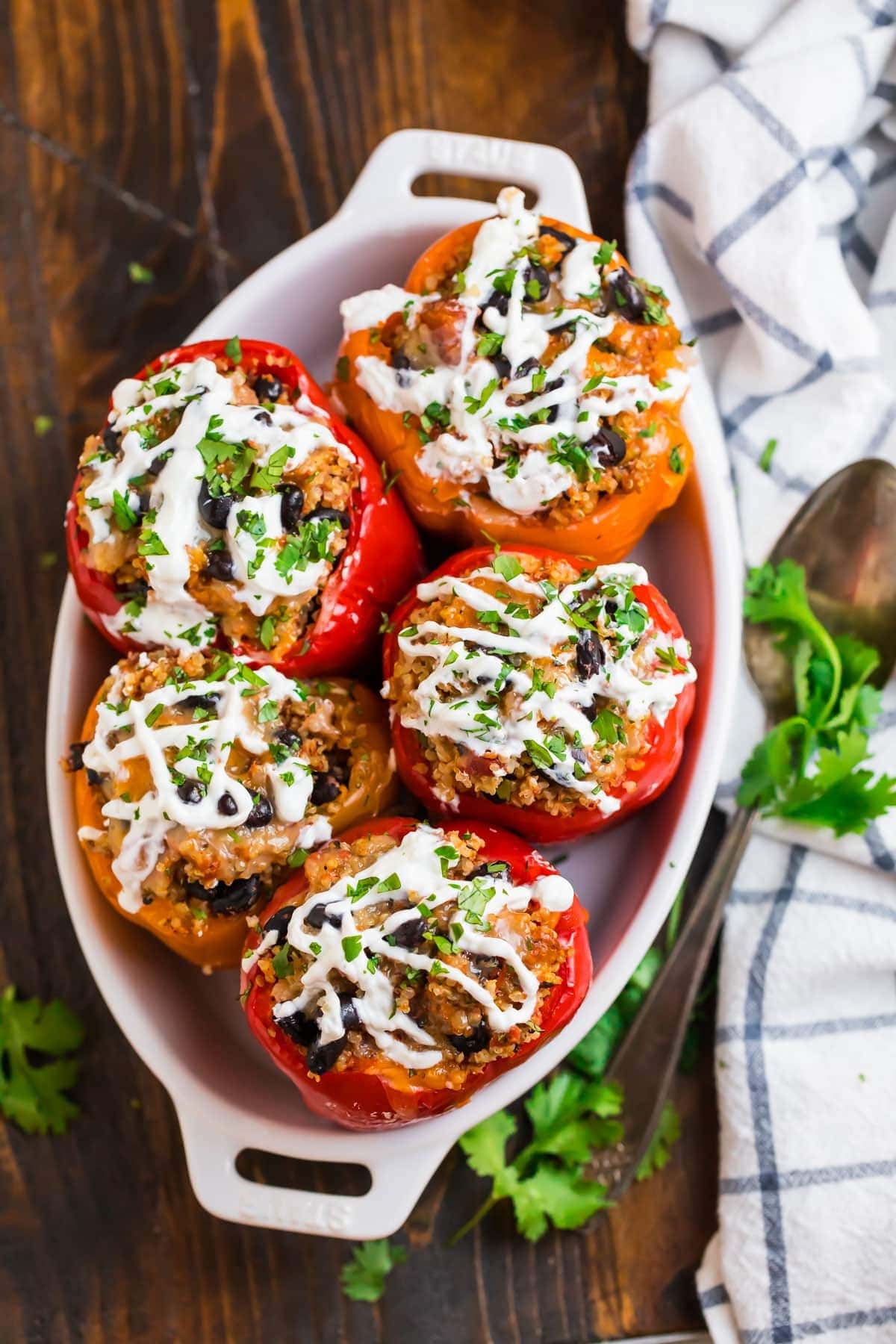 Slow-Cooker Stuffed Peppers on an oval dish garnish with cilantro