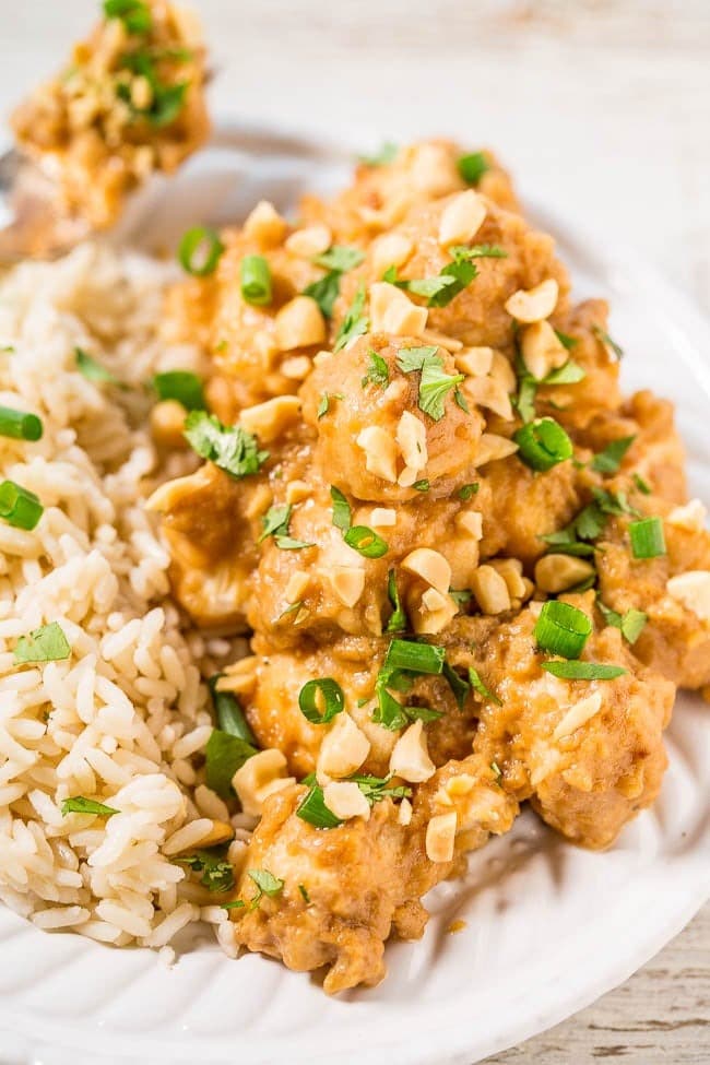 Slow Cooker Thai Peanut Chicken garnished with peanuts and chopped cilantro